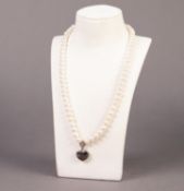 SINGLE STRAND NECKLACE OF FRESHWATER PEARLS with silver clasp and heart shaped pendant front