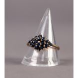 9ct GOLD AND SAPPHIRE RING, the diamond shaped top set with 16 small round sapphires, ring size R/S