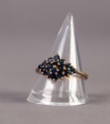 9ct GOLD AND SAPPHIRE RING, the diamond shaped top set with 16 small round sapphires, ring size R/S