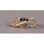 9ct GOLD SCROLL BROOCH set with three marquise shaped sapphires