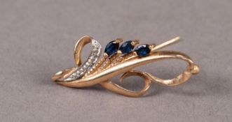 9ct GOLD SCROLL BROOCH set with three marquise shaped sapphires