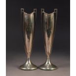 GEORGE V STYLISH PAIR OF TWO HANDLED WEIGHTED SILVER SPECIMEN VASES, each of slender oval footed