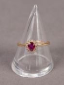 18ct GOLD RUBY AND DIAMOND CLUSTER RING, size ?N/O? 2.2 gms