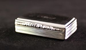 A WILLIAM IV SILVER SNUFF BOX, engine turned and with embossed floriated thumb piece, the cover