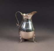 GEORGE V PLAIN SILVER CREAM JUG, of pyriform with shaped rim, scroll handle and shell capped