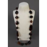 RECONSTITUTED DARK GOLDEN BROWN AMBER NECKLACE of round and large irregular shaped beads, well