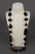 RECONSTITUTED DARK GOLDEN BROWN AMBER NECKLACE of round and large irregular shaped beads, well