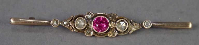 19TH CENTURY BAR BROOCH COLLET SET WITH A CENTRE VIBRANT RED CEYLON SPINEL, flanked by two collet