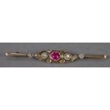 19TH CENTURY BAR BROOCH COLLET SET WITH A CENTRE VIBRANT RED CEYLON SPINEL, flanked by two collet