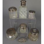 SEVEN GLASS CONTAINERS WITH PULL-OFF SILVER LIDS, toilet jars, scent bottle (glass a/f), hair
