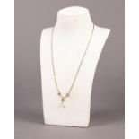 FINE BOX LINK CHAIN NECKLACE with scroll pattern front having a single pearl drop, marked ?585?, 3.8