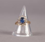 18ct GOLD, SAPPHIRE AND DIAMOND CLUSTER RING, set with a centre oval sapphire and surround of 10