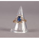18ct GOLD, SAPPHIRE AND DIAMOND CLUSTER RING, set with a centre oval sapphire and surround of 10