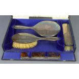 *GEORGE V CASED FOUR PIECE PLAIN SILVER CLAD HAND MIRROR AND BRUSH SET, including a tortoiseshell