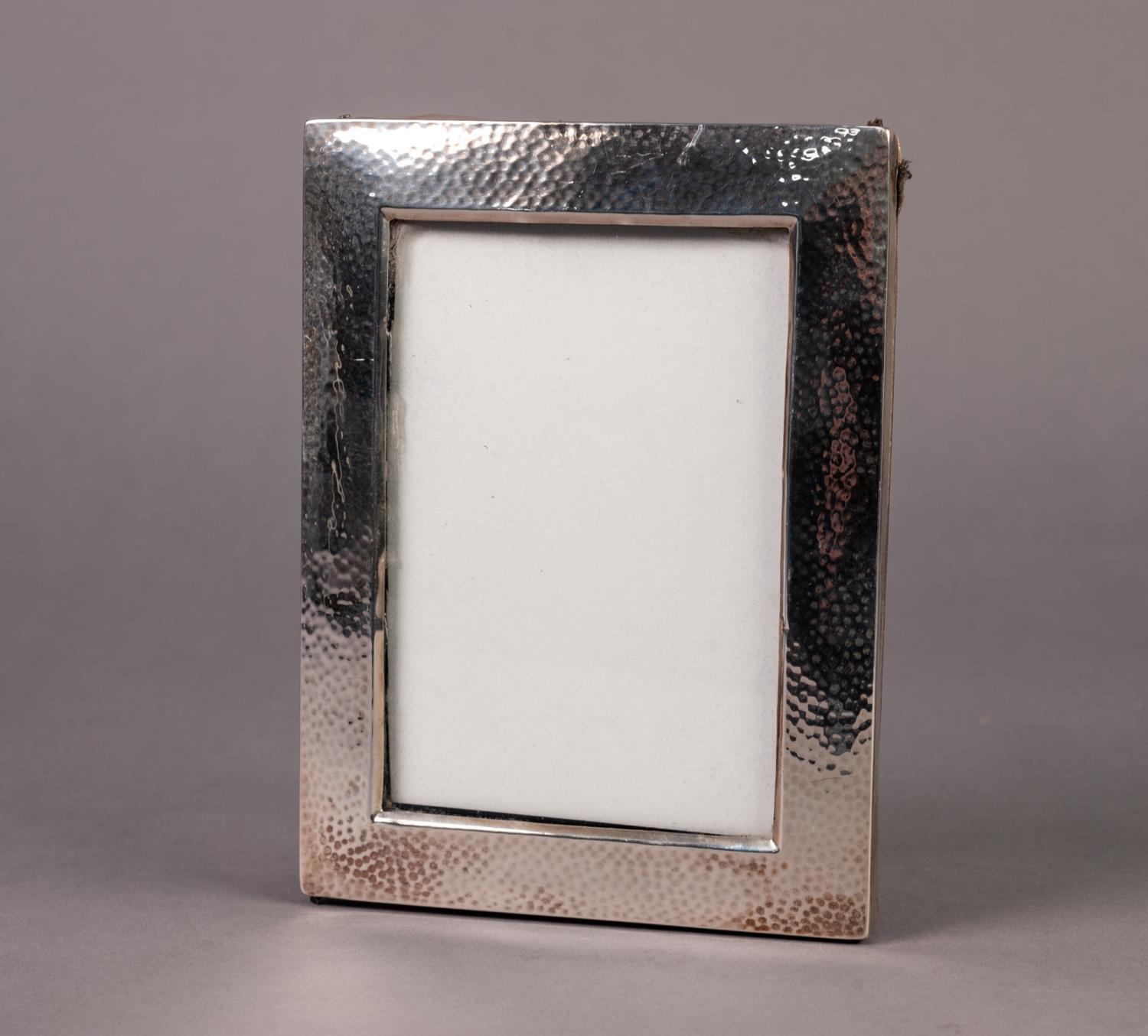 PLANISHED SILVER FRONTED PHOTOGRAPH FRAME, of oblong form, lacking easel support, marks rubbed, 7