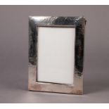 PLANISHED SILVER FRONTED PHOTOGRAPH FRAME, of oblong form, lacking easel support, marks rubbed, 7