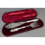 GOOD PAIR OF CASED MID VICTORIAN SILVER FISH SERVERS, the filled handles stamped with leafage, the