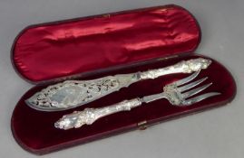 GOOD PAIR OF CASED MID VICTORIAN SILVER FISH SERVERS, the filled handles stamped with leafage, the