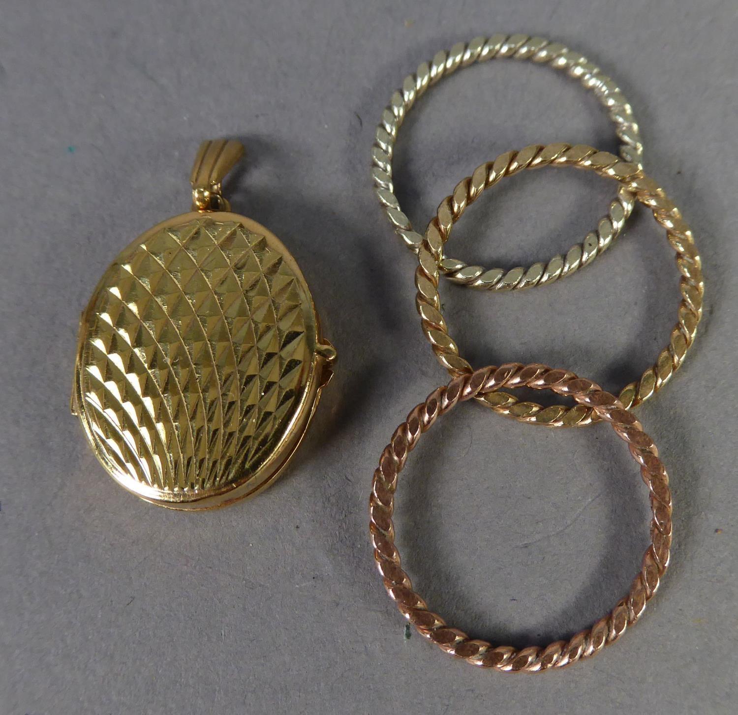 9ct GOLD SMALL OVAL LOCKET PENDANT with engine turned decoration and a set of THREE HALLMARKED 9ct