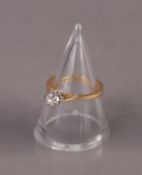 18ct GOLD RING WITH A ROUND BRILLIANT CUT SOLITAIRE DIAMOND, in a six claw setting, approximately