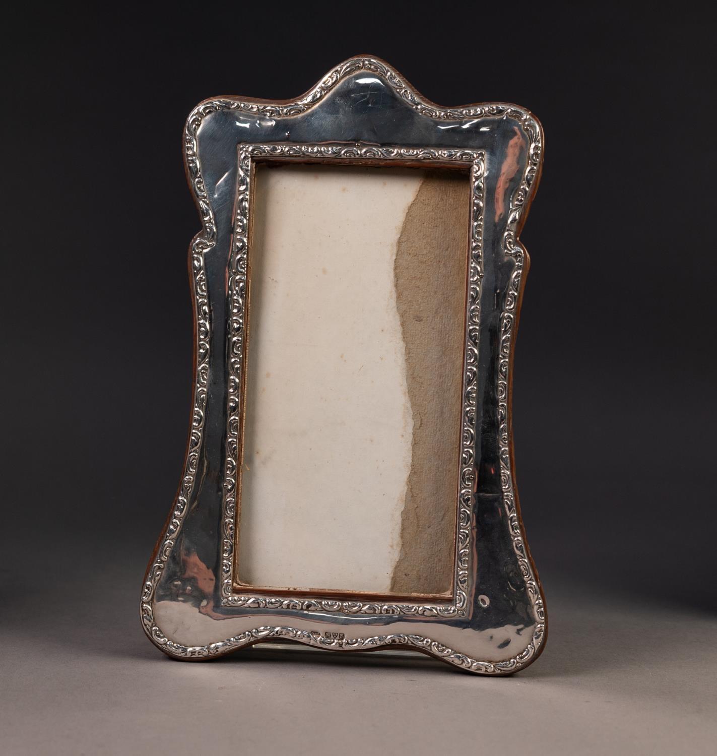 EDWARD VII SILVER FRONTED OAK DESK TOP PHOTOGRAPH FRAME, of wavy outline with arch top and
