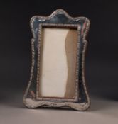 EDWARD VII SILVER FRONTED OAK DESK TOP PHOTOGRAPH FRAME, of wavy outline with arch top and