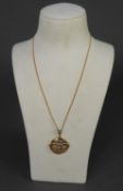 9ct GOLD OPENWORK CIRCULAR PENDANT ON GILT METAL FINE CHAIN, the pendant 2.3 gms