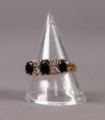 9ct GOLD RING SET WITH THREE OVAL SAPPHIRES, separated by two pairs of small diamonds, ring size