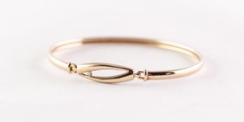 GOLD COLOURED METAL, UNMARKED, BANGLE, set with a tiny diamond in 'Touch' wooden box, 5.9gms
