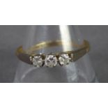 18ct GOLD RING claw set with three small round brilliant cut diamonds, approximately 0/25ct in