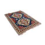 CAUCASIAN FLAT WEAVE RUG, with two large octagonal medallions, on a blue field having brick red