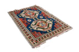 CAUCASIAN FLAT WEAVE RUG, with two large octagonal medallions, on a blue field having brick red