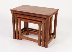 MOUSEMAN THOMPSON NEST OF THREE OAK TABLES with adzed tops and polygonal chamfered legs with