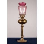 ART NOUVEAU EMBOSSED OIL TABLE LAMP with fluted column, floral embossed spreading foot, clear