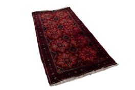 SHIRAZ PERSIAN RUG, with two rows of five stellate medallions, stencilled on the dark crimson