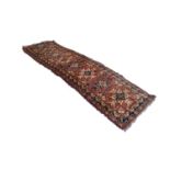 SHIRAZ PERSIAN RUNNER with eight splash pattern medallions in blue and fawn on a wine red and floral