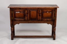 JACOBEAN STYLE MODERN REPRODUCTION DISTRESSED OAK SMALL DRESSER, the oblong top above a central