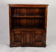 JACOBEAN STYLE MODERN REPRODUCTION DISTRESSED OAK OPEN BOOKCASE, the moulded oblong top above a