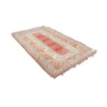 TURKISH LARGE ALL-WOOL EMBOSSED RUG, with a narrow salmon pink central panel with five square repeat