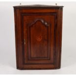 LATE EIGHTEENTH CENTURY OAK AND MAHOGANY CROSSBANDED FLAT FRONTED CORNER CUPBOARD, of typical form