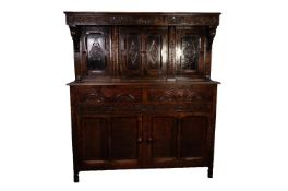 TWENTIETH CENTURY CARVED OAK COURT CUPBOARD, the canopy top with foliate and scroll chip carved