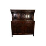 TWENTIETH CENTURY CARVED OAK COURT CUPBOARD, the canopy top with foliate and scroll chip carved