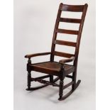 NINETEENTH CENTURY FRUITWOOD LADDER BACK ROCKING CHAIR, of typical with high back, rush sea, flat