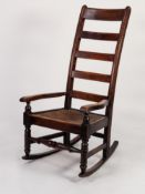 NINETEENTH CENTURY FRUITWOOD LADDER BACK ROCKING CHAIR, of typical with high back, rush sea, flat