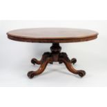 VICTORIAN FIGURED AND CARVED MAHOGANY LOO TABLE, the moulded, oval, flame , tilt-top above a