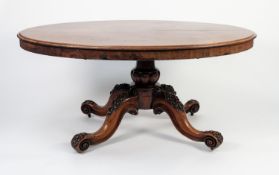 VICTORIAN FIGURED AND CARVED MAHOGANY LOO TABLE, the moulded, oval, flame , tilt-top above a