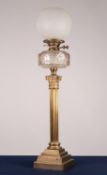 EARLY TWENTIETH CENTURY BRASS CORINTHIAN COLUMN PATTERN OIL TABLE LAMP, with stepped square base,