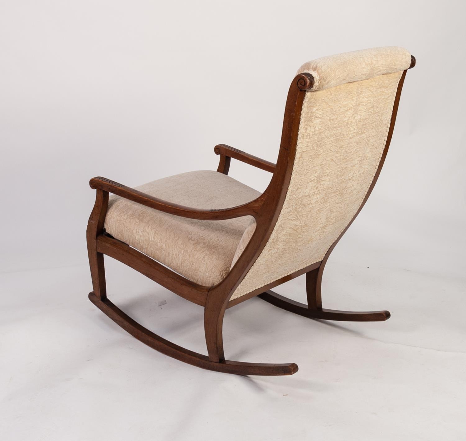 EDWARDIAN MAHOGANY UPHOLSTERED ROCKING CHAIR, the buttoned back flanked by leaf capped downswept - Image 2 of 2