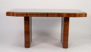 ART DECO FIGURED WALNUT DINING TABLE, the quarter cut, canted oblong top, with glass protector,