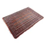 PAKISTAN BOKHARA LARGE RUG, with three rows of fifteen primary guls on a brick red field, broad